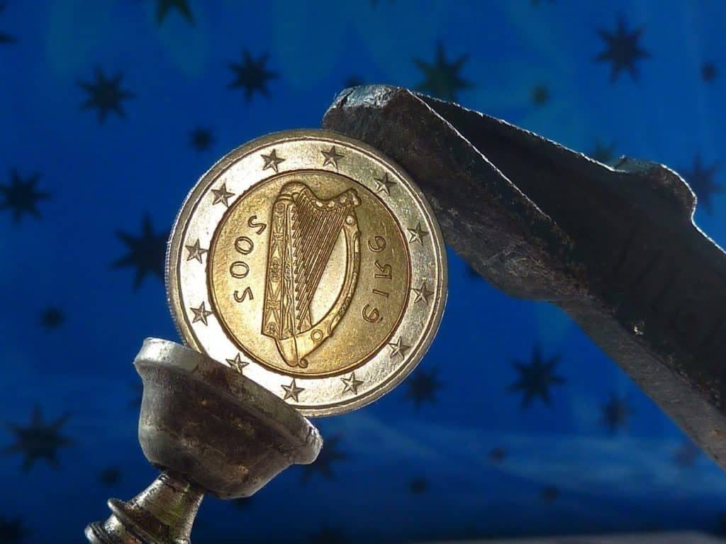 Irish two euro coin with harp design held in a metal clamp